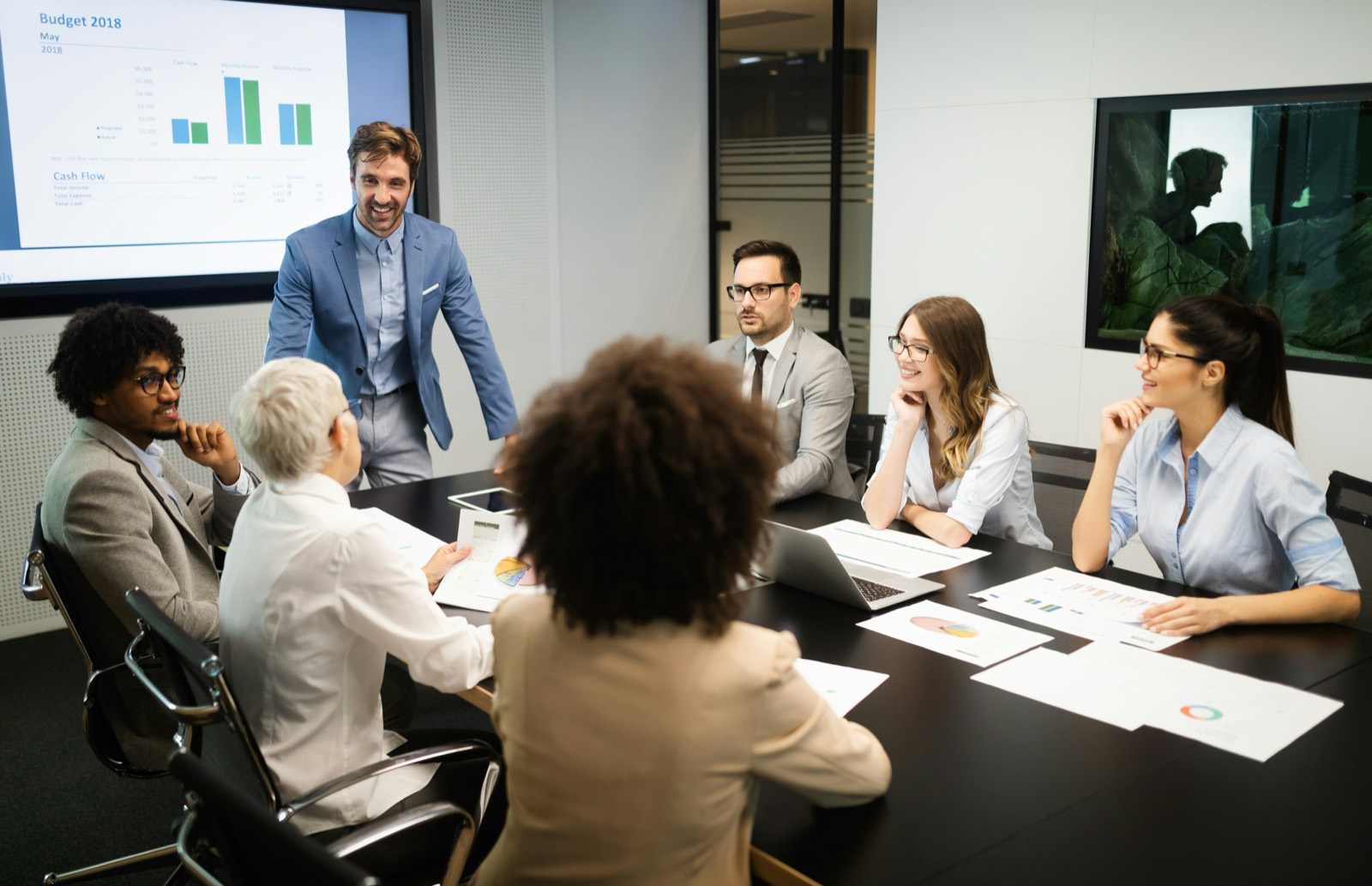 Trainer presenting to a team in a boardroom session